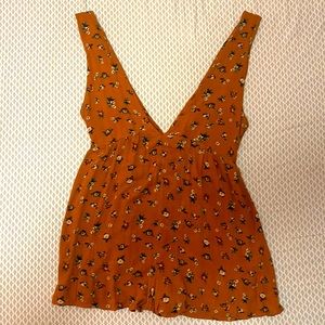 A sienna romper with small flower designs; bring on the desert vibes!
